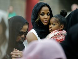 Muhammad Ali's wife Lonnie and her daughter Laila attend Muhammad Ali's Jenazah, a traditional Islamic Muslim service, in Freedom Hall, Thursday, June 9, 2016, in Louisville, Ky. Laila is holding her daughter Sydney Jurldine Conway.